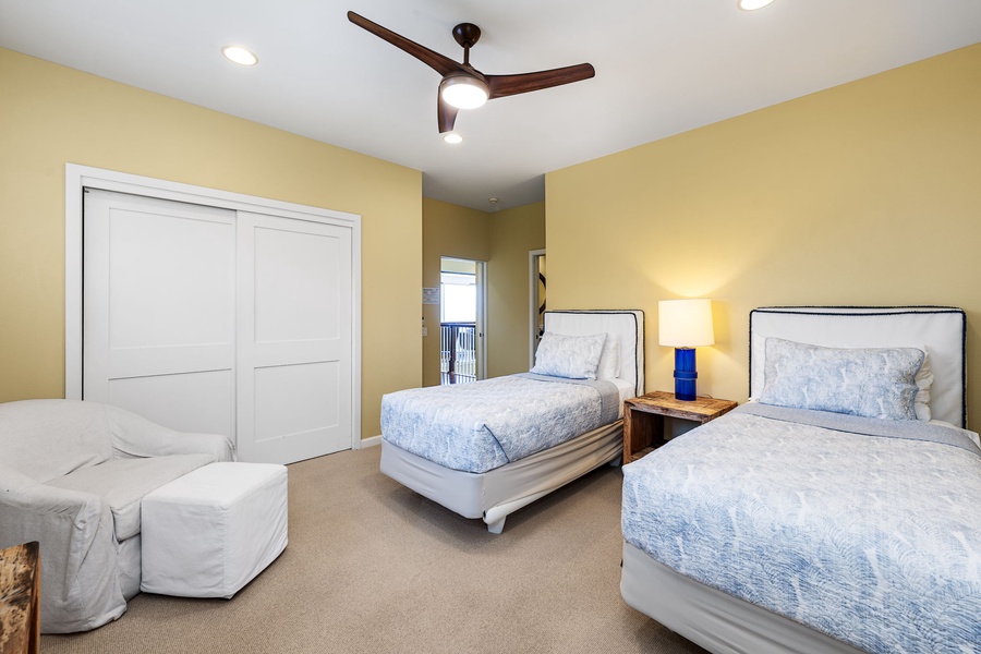 Twin bedroom perfect for children or additional guests, featuring two comfortable beds and warm lighting.