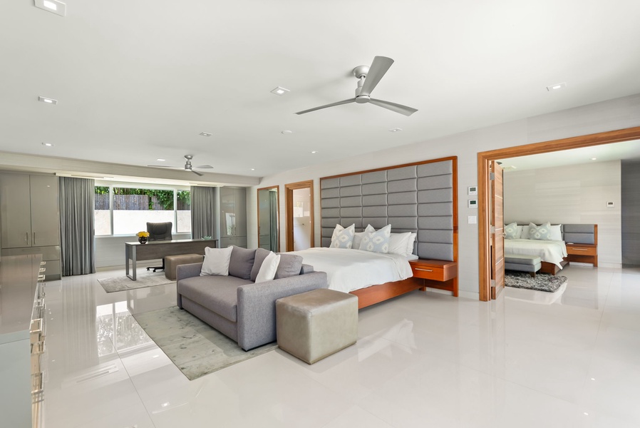 Step into your bright, contemporary suite where sleek white tile floors and a plush king bed create a modern sanctuary. Relax on the stylish sectional, enjoy dedicated workspace, and open connecting doors to expand your space.
