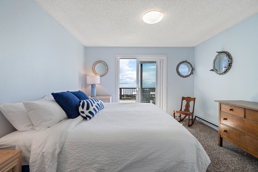 The primary bedroom is a peaceful retreat with a king-size bed, ample storage, and large windows that let in plenty of natural light.