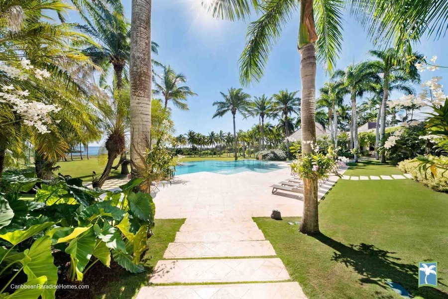 Wander down the elegant pathway leading to a pristine pool.