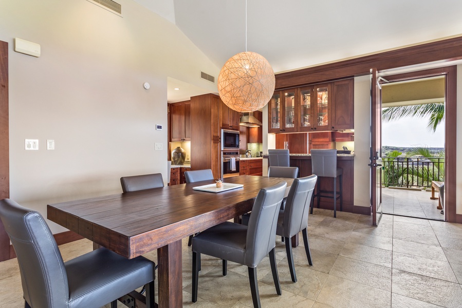 Dining table for 6 with view to the kitchen bar area.