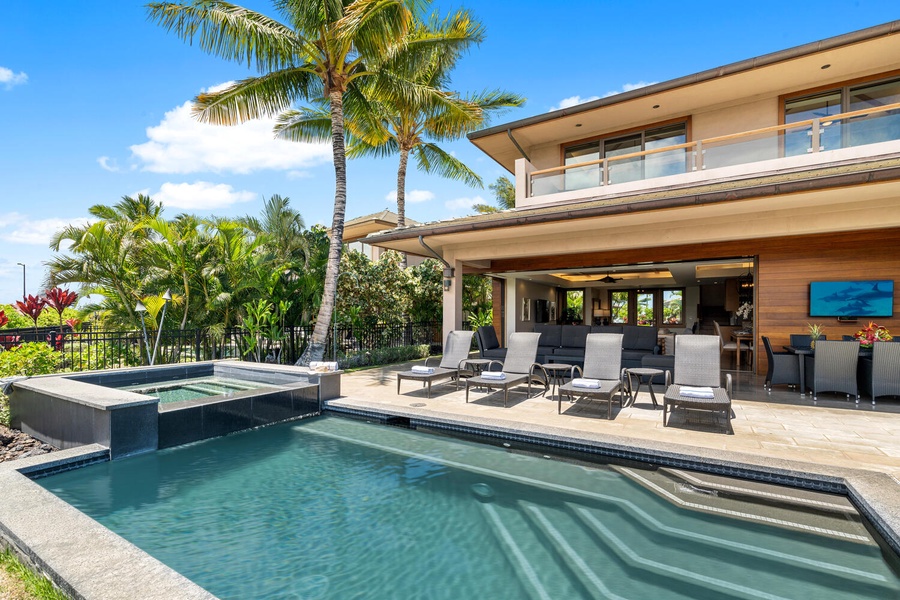 Private pool and spa with sun loungers and seamless indoor-outdoor access.