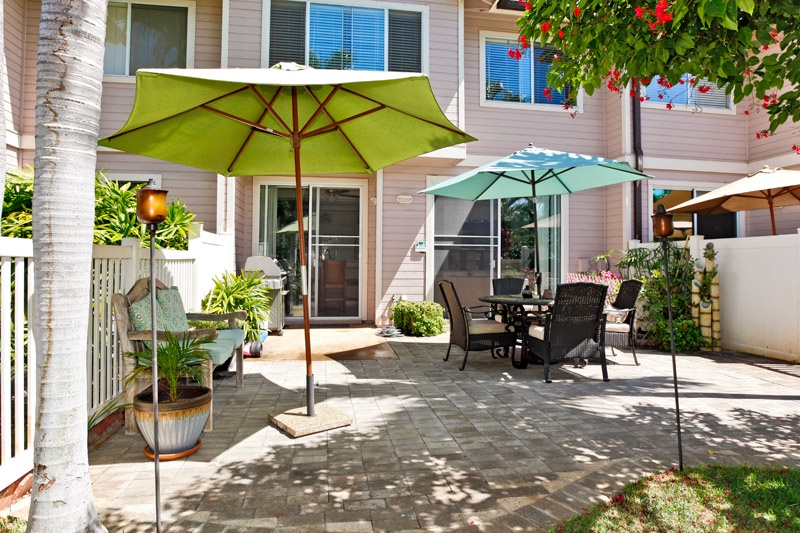 The natural stone pavers and bright tropical plants bring a warm welcome.
