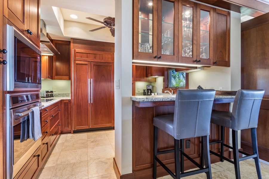 Kitchen bar seating and Wolf oven and microwave detail.