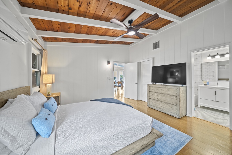 Spacious primary suite angle highlighting ample storage, calming décor, and room to unwind after a day in the sun.