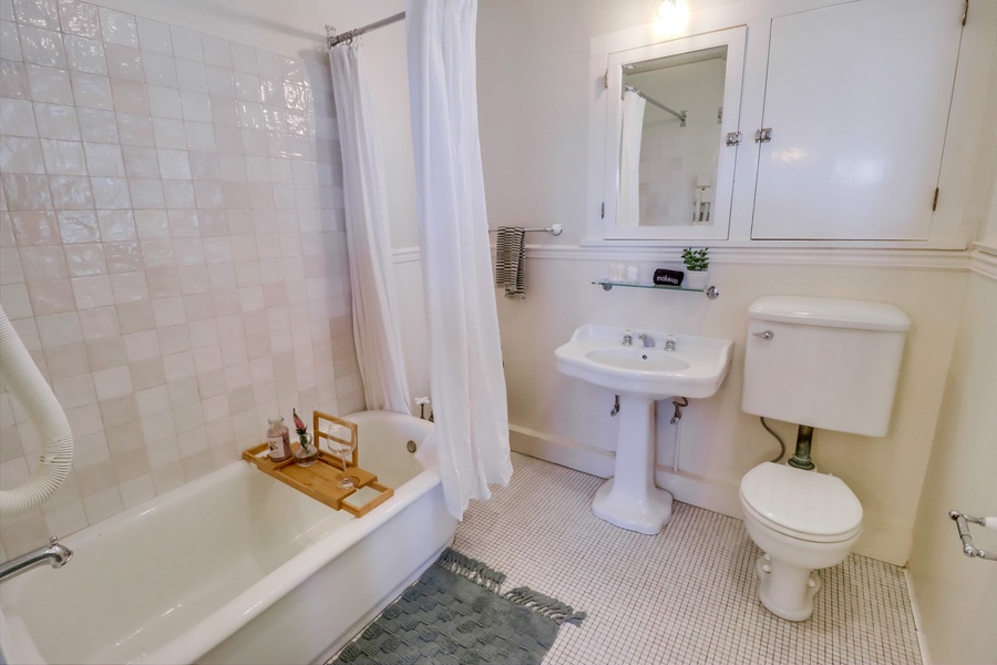 Indulge in a tranquil escape as you sink into the bathroom’s exquisite antique soaking tub, perfect for a moment of pure relaxation.