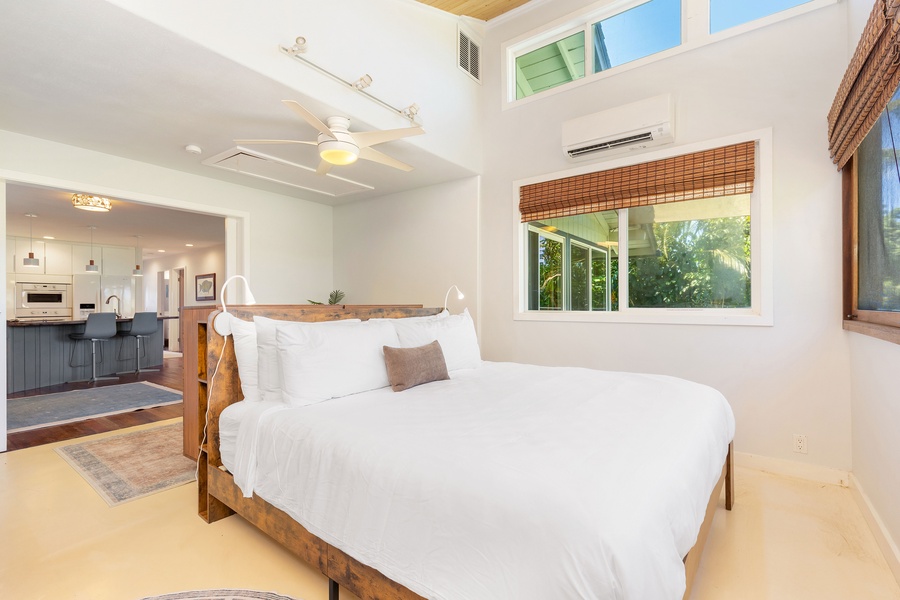 The primary suite features a king bed, split AC, and easy access to the lanai for a breezy tropical vibe.