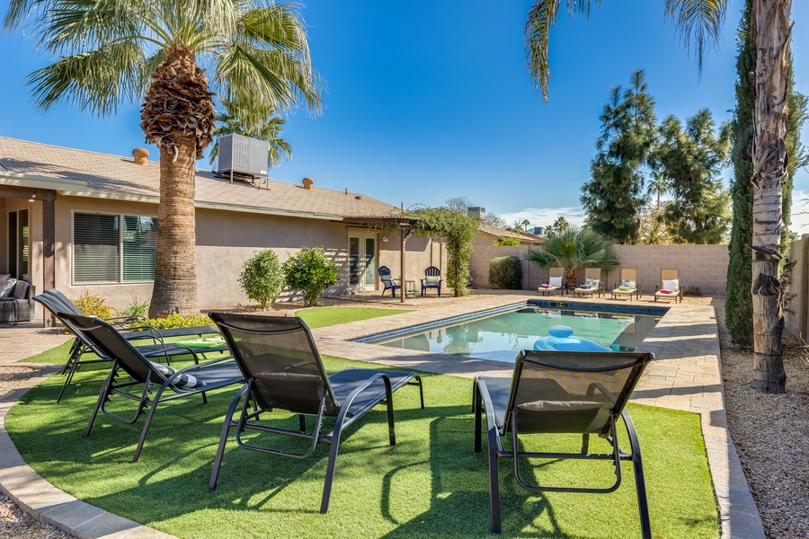 Step outside and enjoy the peacefulness of the backyard, complete with a beautiful pool, fire pit, and seating for all.