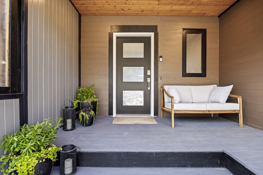 Welcoming front entryway with covered porch and seating — a warm Pacific Northwest greeting.