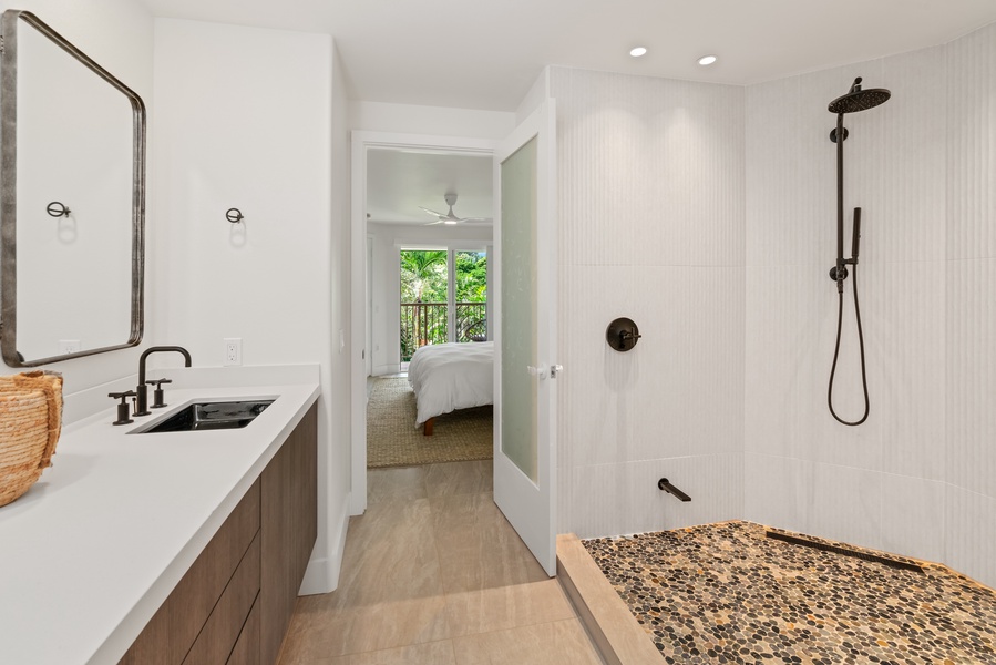 Spa-inspired bath with walk-in shower, garden view, and stylish fixtures.