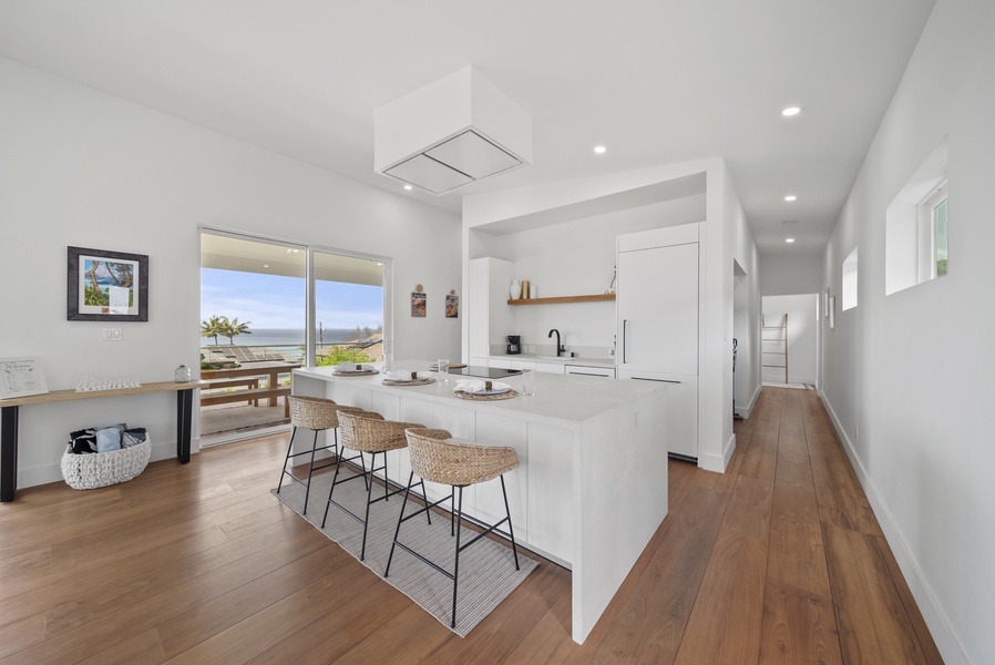 Cook and connect in the fully stocked kitchen with island seating for three.
