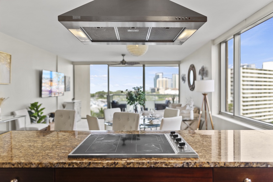 The kitchen has expansive counter space and an electric stove with views through the lanai.