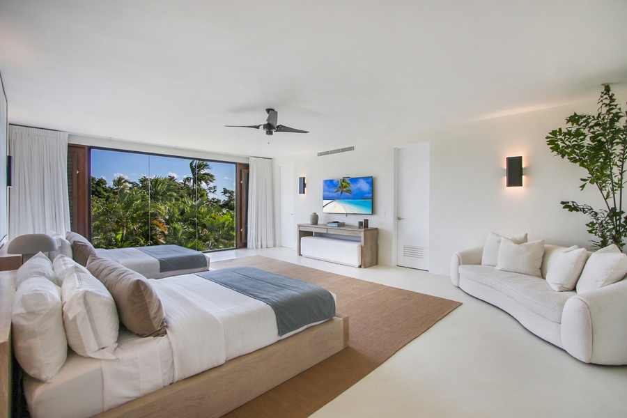 Retreat in the guest bedroom with two beds and a comfortable seating area.