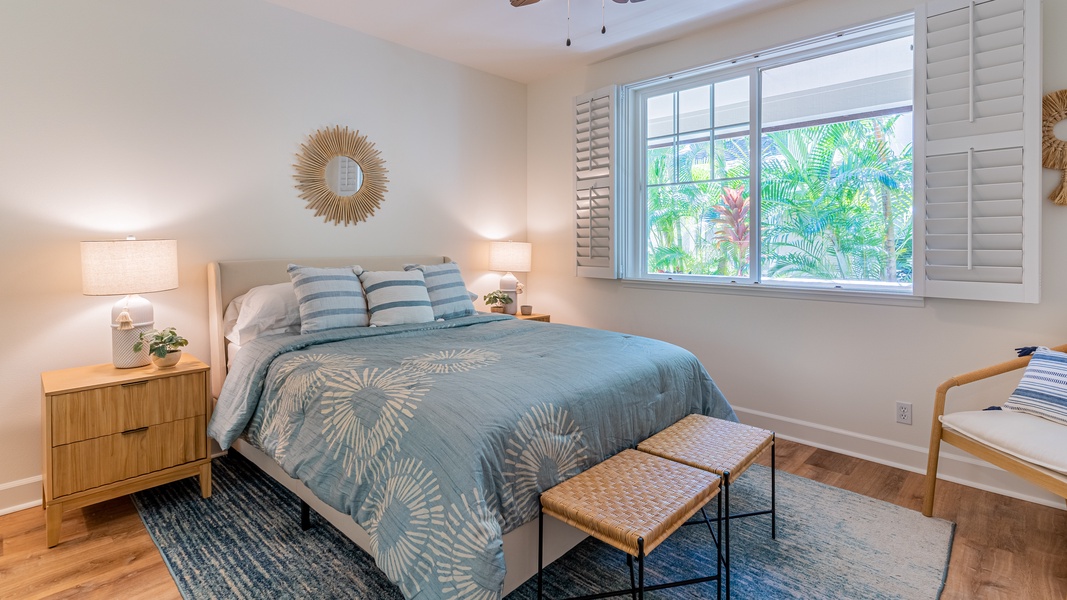 The second guest bedroom with natural lighting and soft blue tones.
