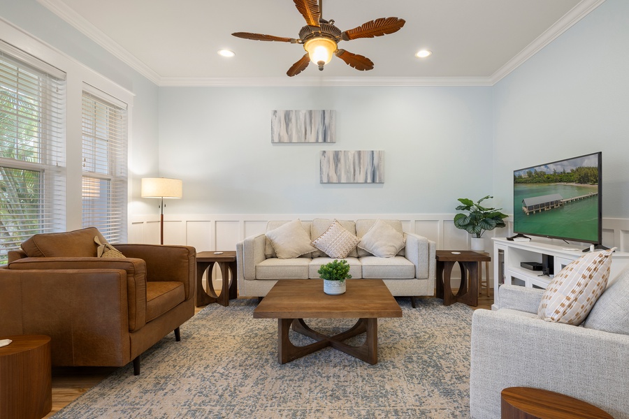 Sink into comfort in the inviting living room, styled with rich textures and ceiling fan cooling.