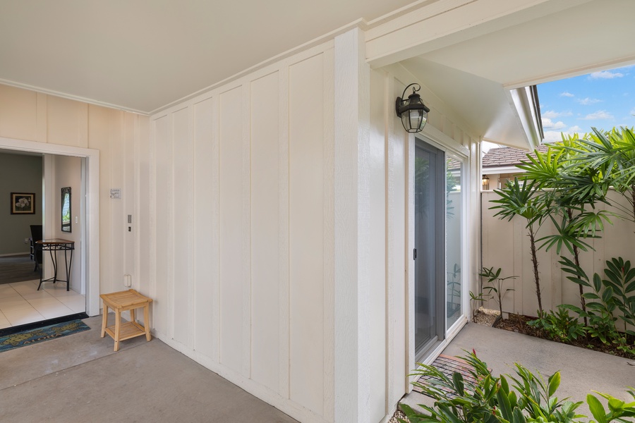Welcoming entryway with plantation-style charm and tropical landscape accents.