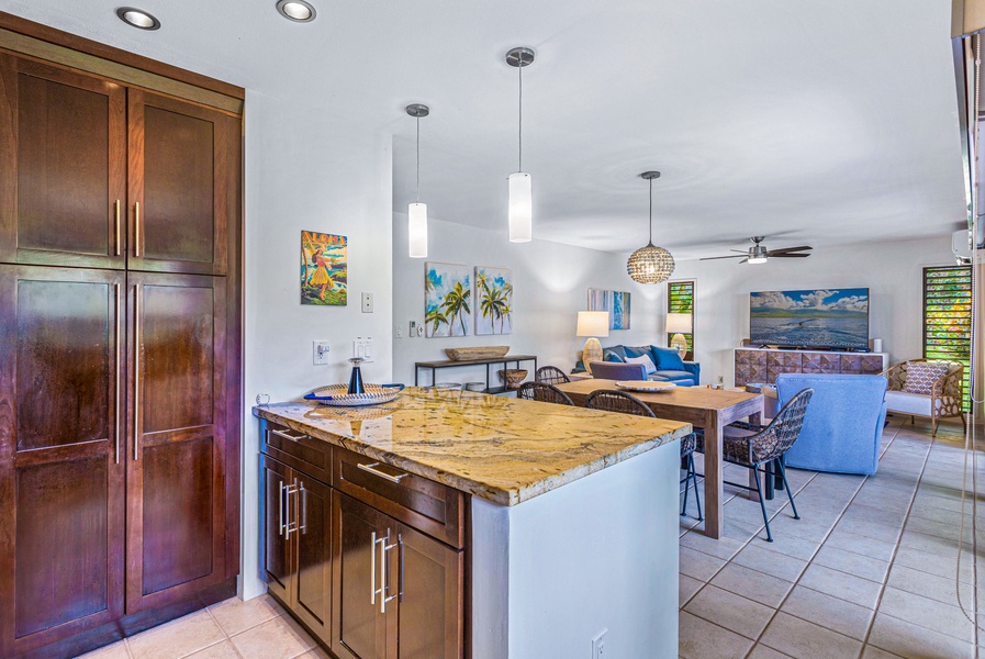 The open kitchen island provides extra counter space and flows seamlessly into the living and dining areas, making it great for entertaining or casual meals.