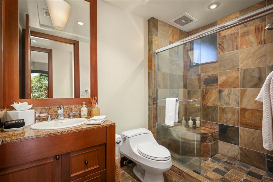 Guest bath with large glass enclosed shower.