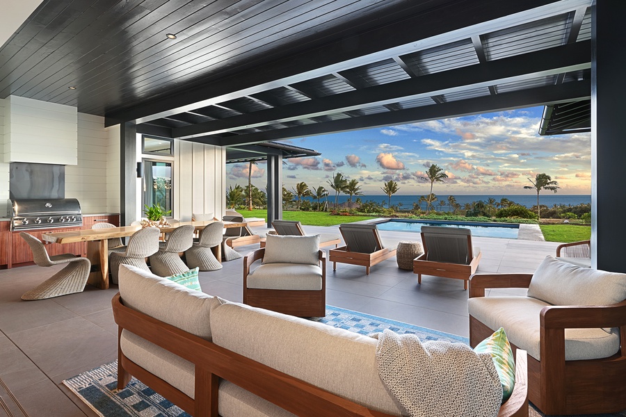 Relax on the lanai with plush seating and stunning views of the ocean and lush greenery.