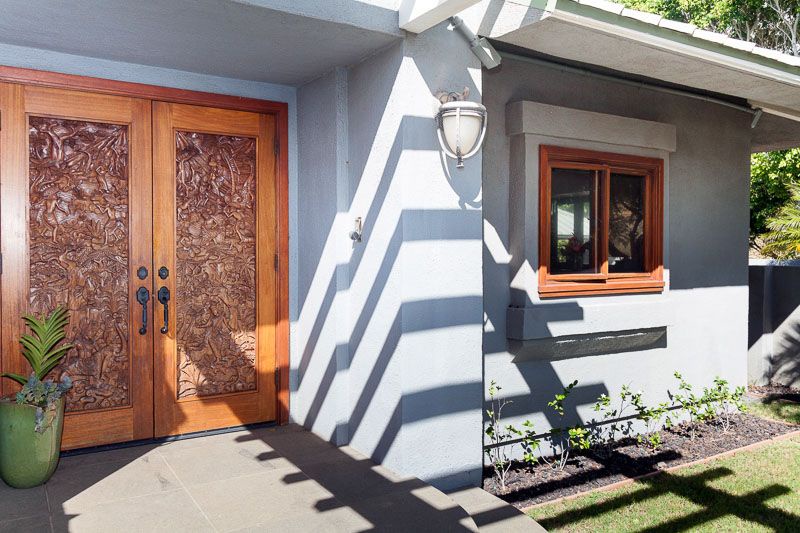 Beautifully hand carved door welcomes you inside this home