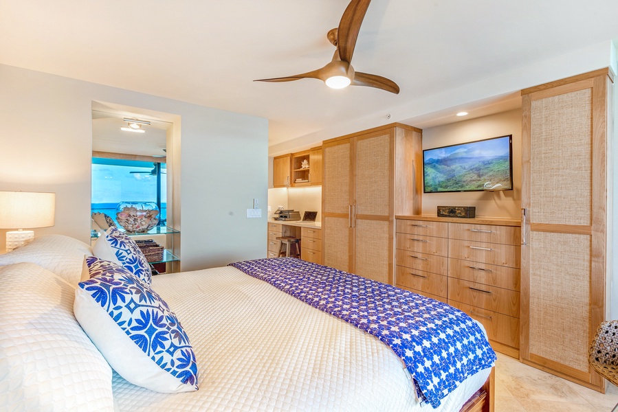 Cozy bedroom with a flat-screen TV and ample storage space.