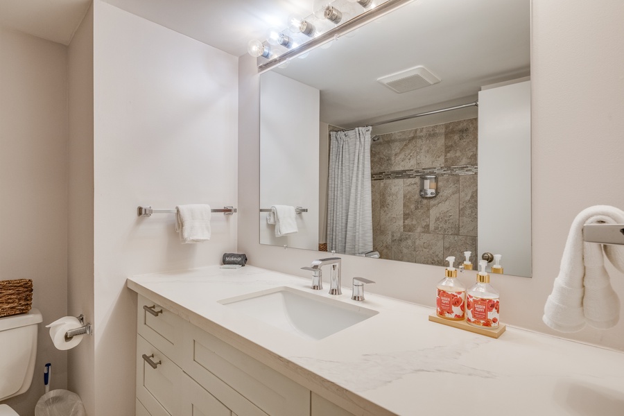 The shared bathroom has a single vanity.