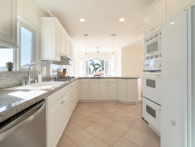 Pristine culinary space with a fully-stocked kitchen and breathtaking window views