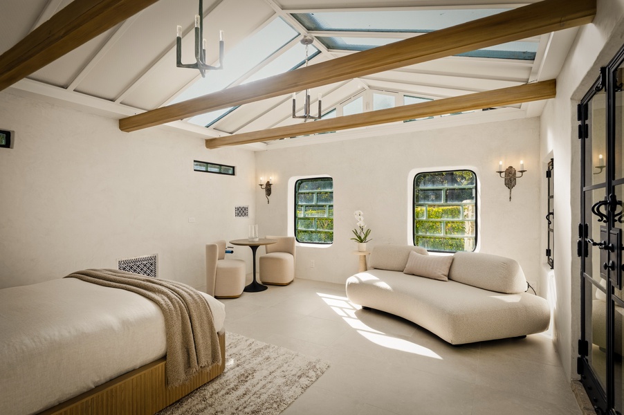 Relax in your stunning bedroom suite with soaring beamed ceilings and skylights that bathe the space in natural light.