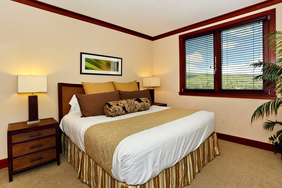 The primary guest bed is comfortable and tastefully decorated.