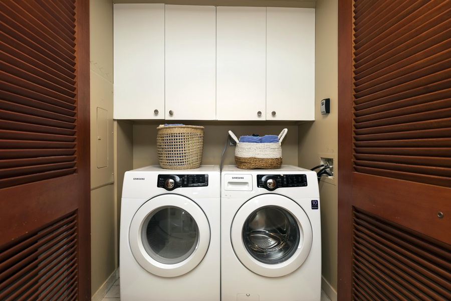 Tucked away are an extra large washer and dryer for your use.