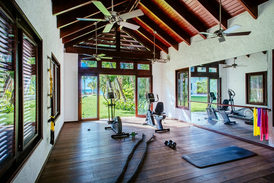 Well-equipped gym with a beautiful garden view.