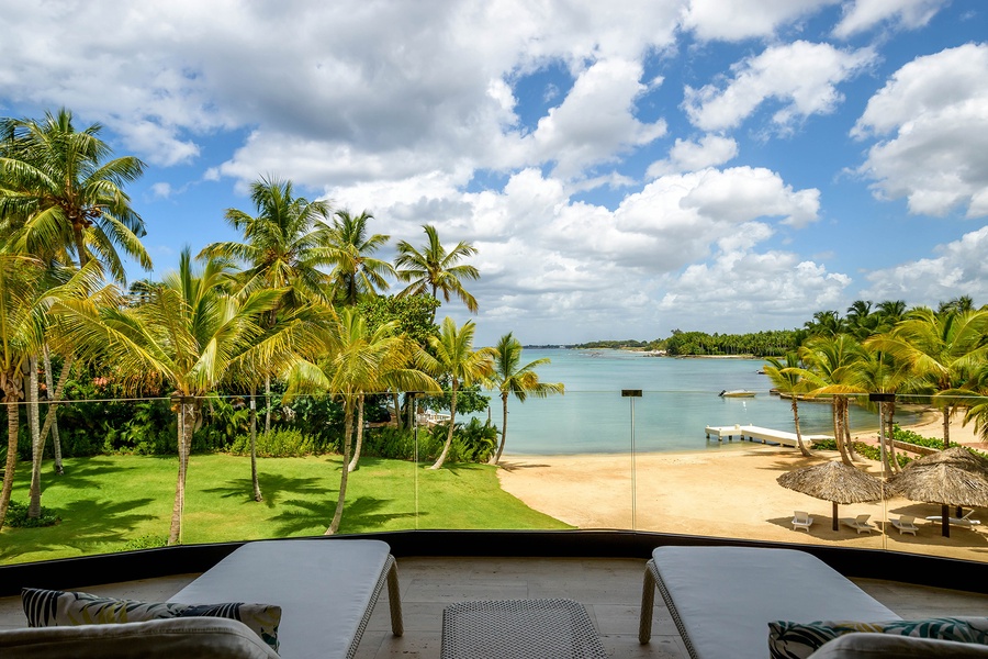 Bask in the breathtaking view of the ocean from your private terrace with comfortable lounge chairs.
