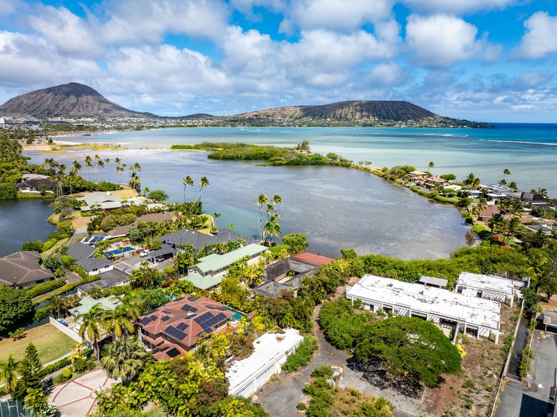 Coastal setting between lagoon waters and volcanic peaks.