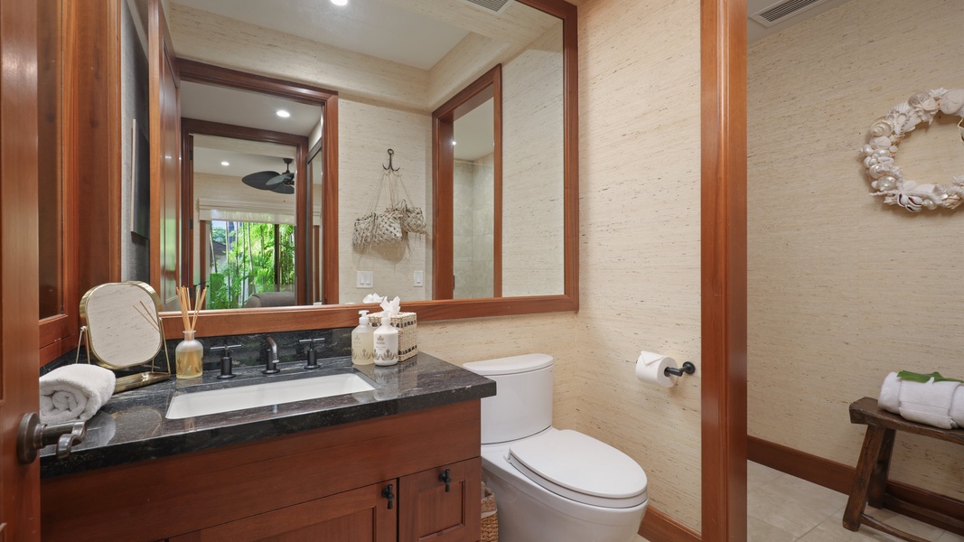 The shared full bathroom downstairs with vanity and warm wood finishes.