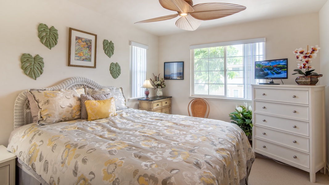 The second guest bedroom with a ceiling fan and soft linens.