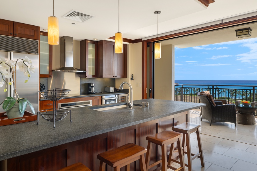 Bright kitchen with island, bar seating and breathtaking views.