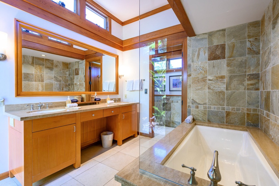 The ensuite bathroom feature a soaker tub and shower, providing a spa-like experience for all guests.