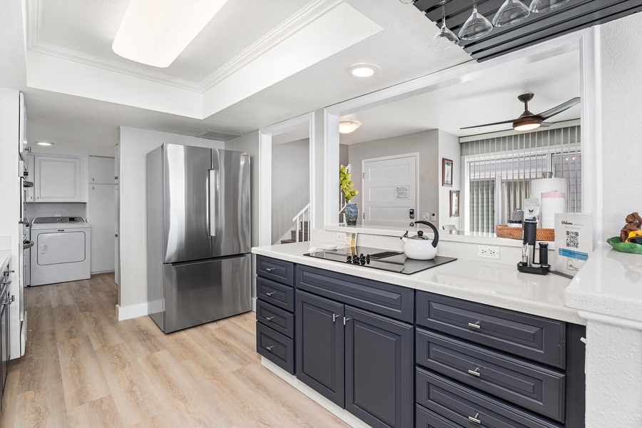 Kitchen view with stainless steel fridge and ample counter space for prepping meals.