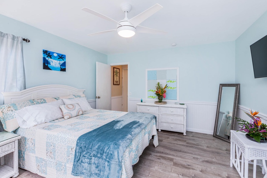 A bright guest bedroom complemented by natural light streaming in from the windows.