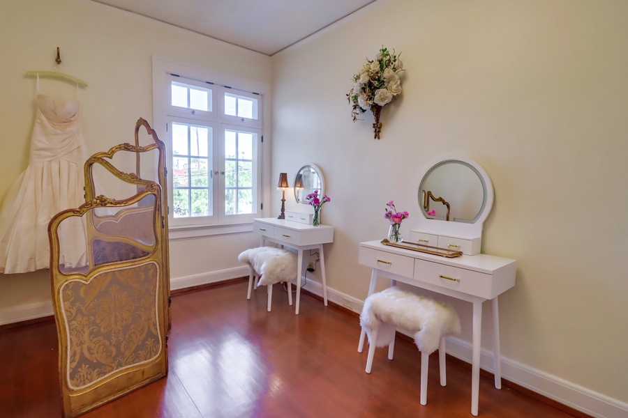 The dressing room has large mirror and two vanity areas.