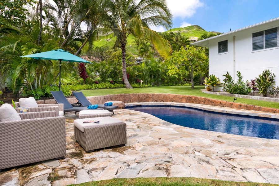 Enjoy a refreshing dip in the in-ground pool, perfect for lazy afternoons and family fun.
