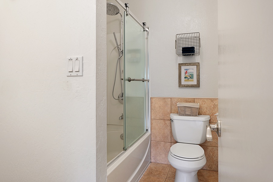The ensuite bathroom has a shower/tub combo.