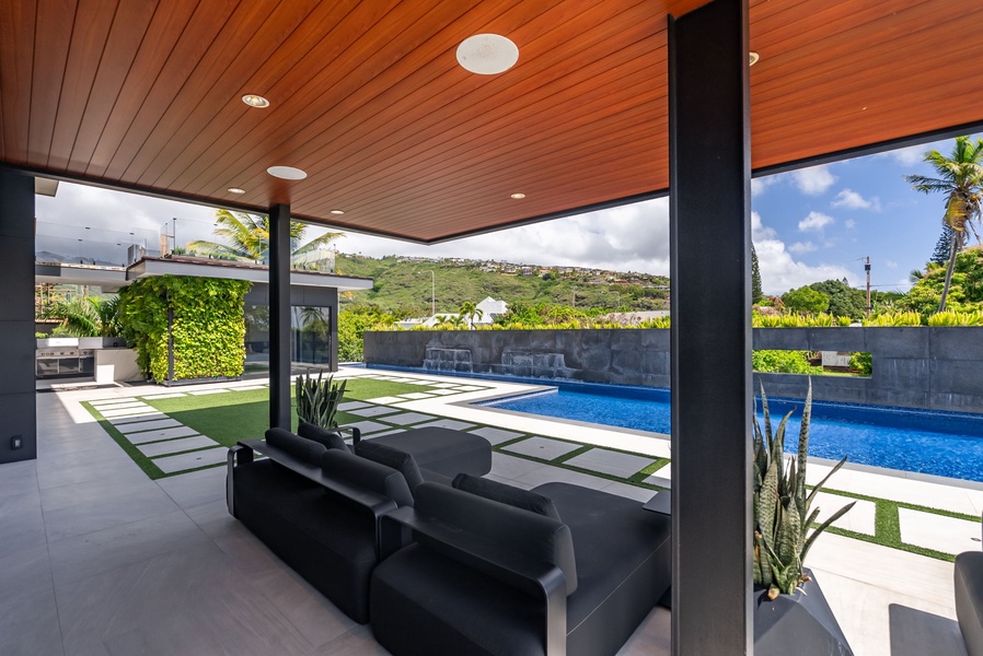 Resort-style comfort under the shaded lounge—designed for effortless indoor-outdoor living.