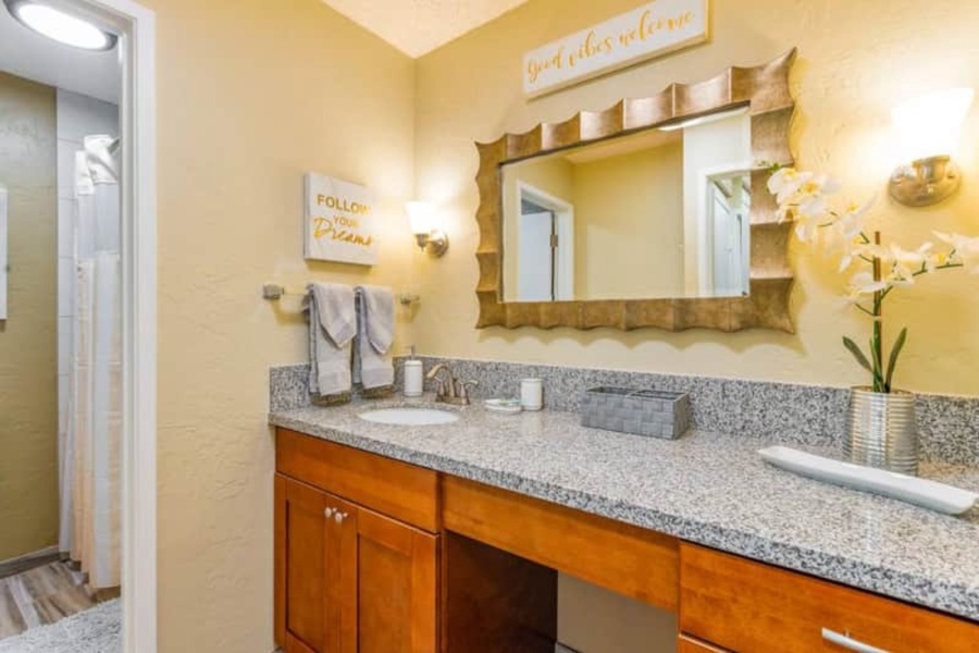 Bathroom provides a large vanity with storage and great lighting