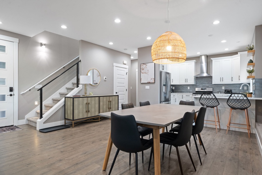 Gather around your spacious dining table in this beautifully designed open-plan space, where modern elegance meets comfort for memorable meals.
