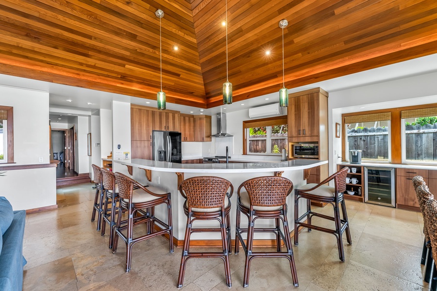 The chef’s kitchen includes modern appliances, bar seating, and plenty of prep space for casual or gourmet meals.