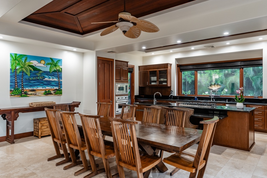 Spacious dining area with a large wooden table and chairs, adjacent to a modern kitchen, perfect for family meals and gatherings.