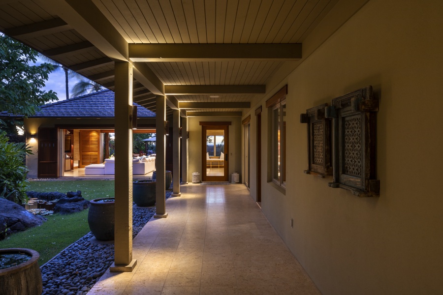 Entry corridor runs alongside garden courtyard with exterior pond & waterfall features toward the main entrance