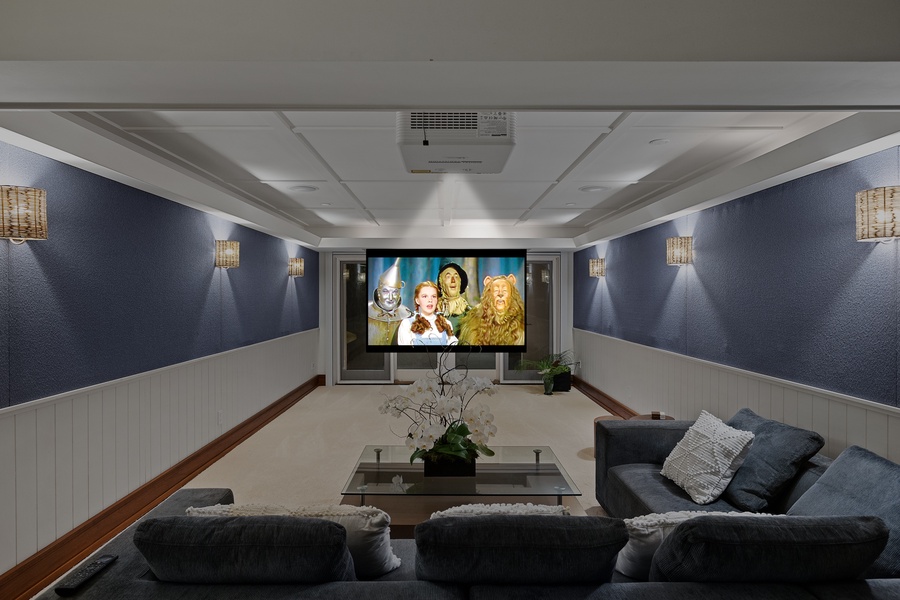 Enjoy the private movie theater featuring comfortable seating and a large screen perfect for movie nights.