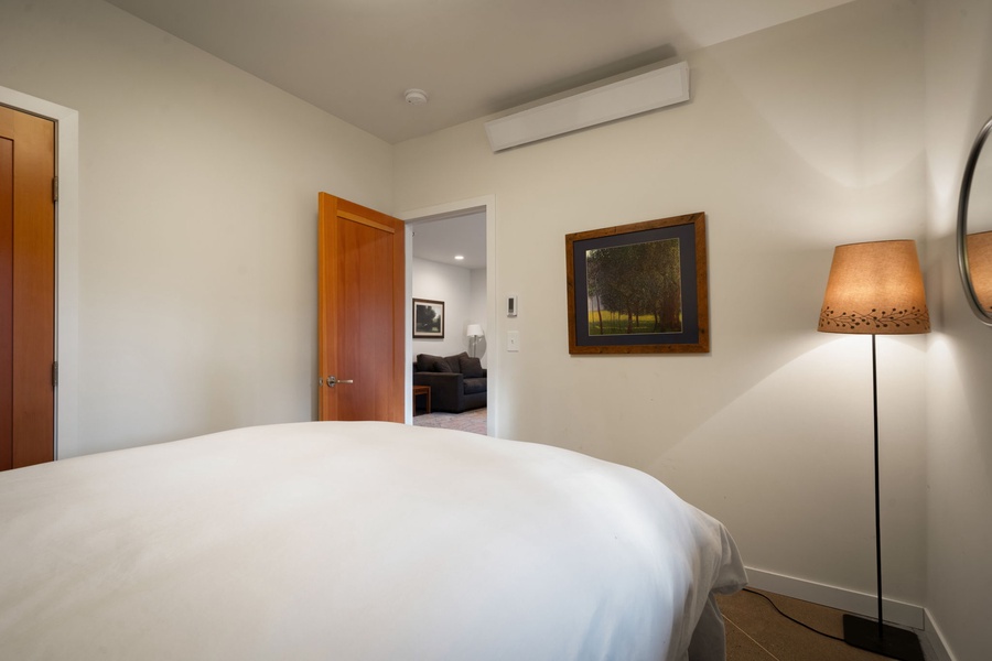 Peaceful bedroom, where warm lighting and thoughtful artwork create the perfect retreat for restful nights.